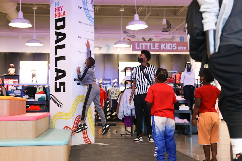 Foot Locker assistant manager Ke’undra Taylor encourages kids to jump as high as possible at...