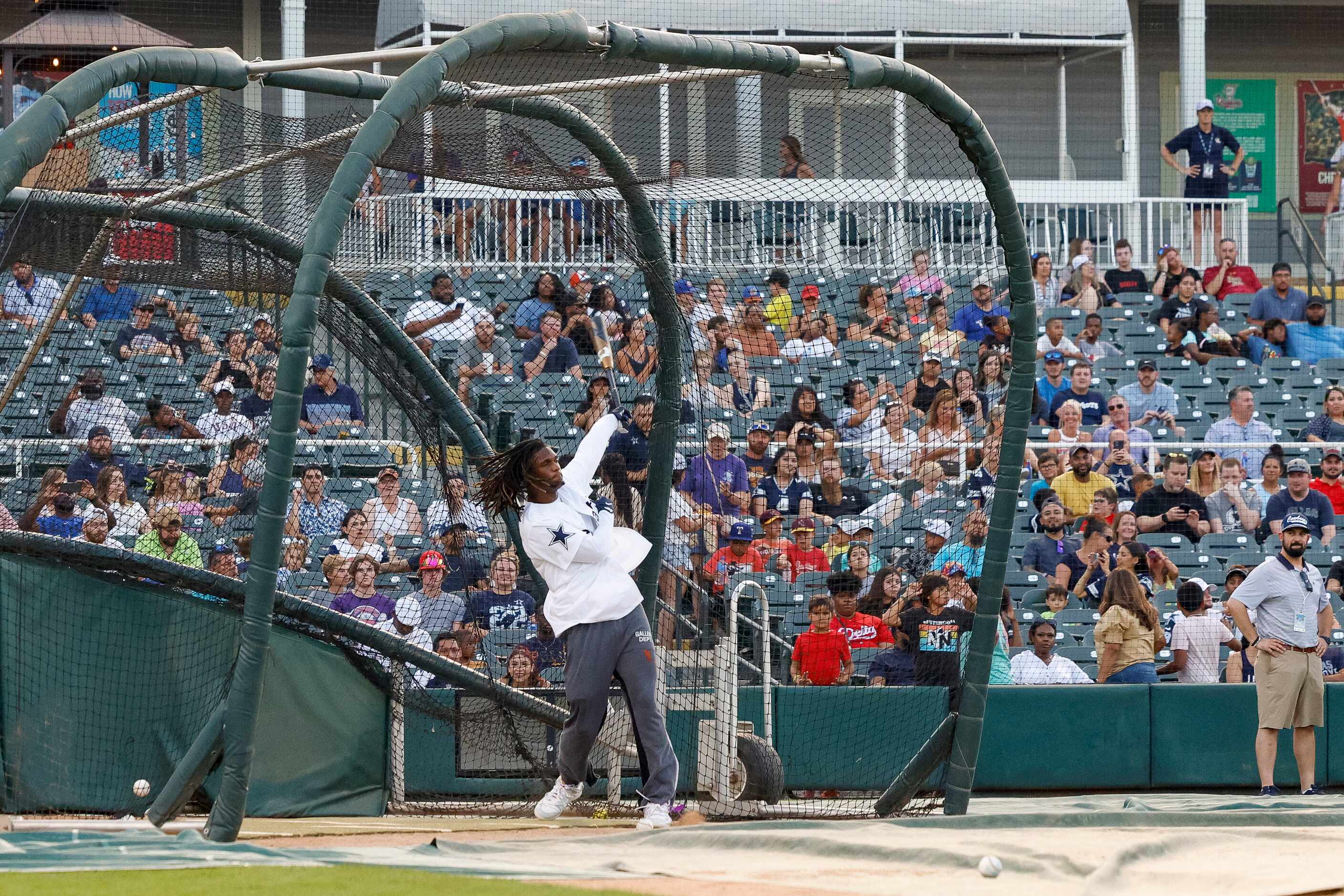 Dallas Cowboys wide receiver CeeDee Lamb watches his ball after hitting a home run during...