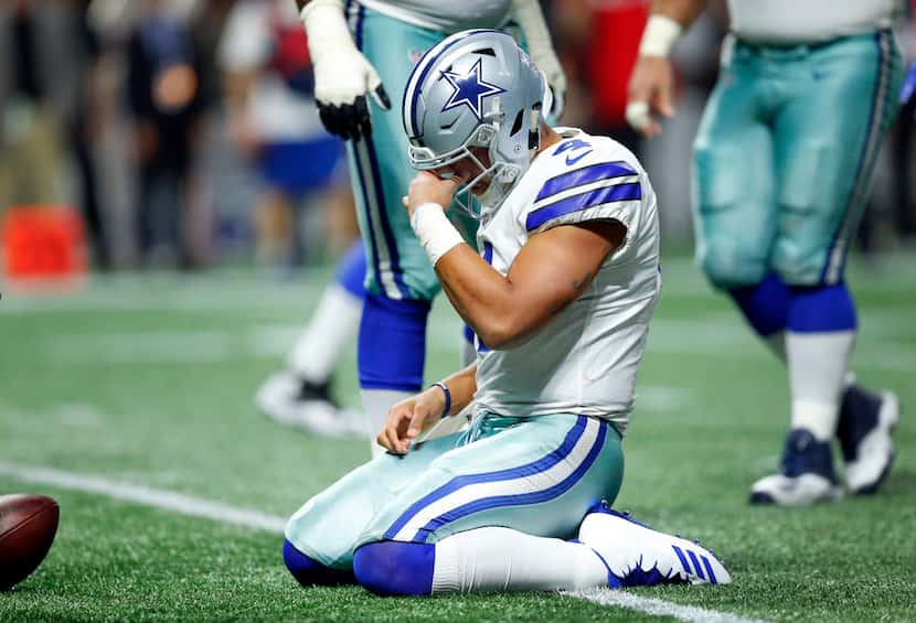Dallas Cowboys quarterback Dak Prescott (4) takes moment after being sacked hard by Atlanta...
