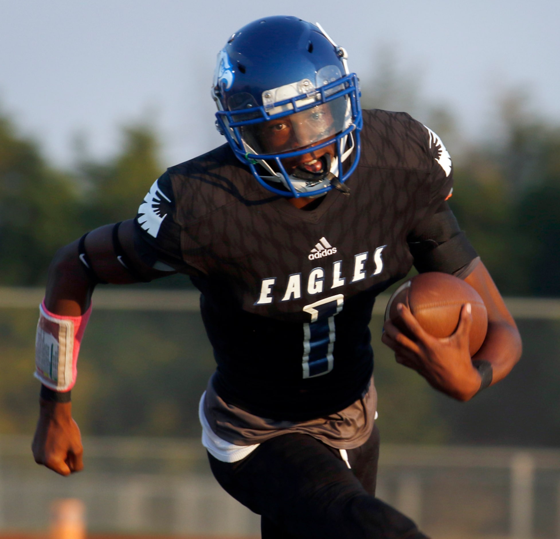 Wilmer Hutchins quarterback Bontay Duncan (1) rolls out of the pocket and runs for a first...