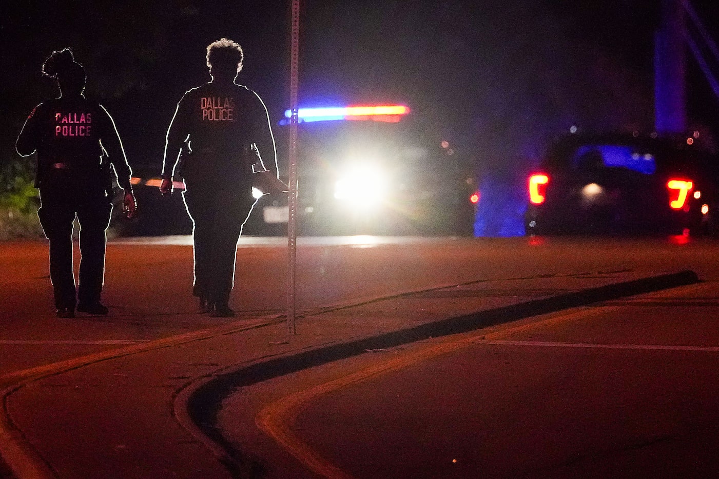 Dallas police work near the scene of a shooting in the 900 block of East Ledbetter Drive,...