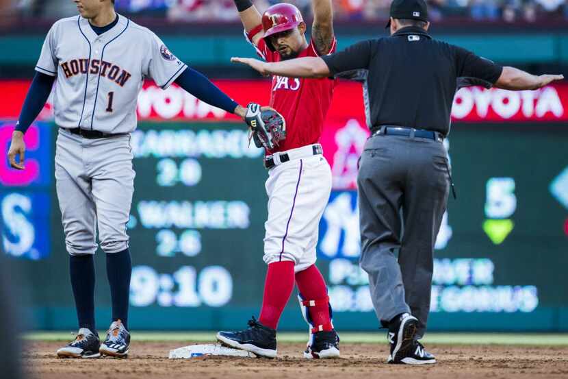 Texas Rangers second baseman Rougned Odor (12) is called safe at second base as Houston...