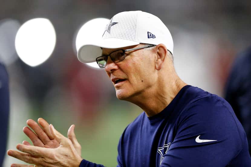 Dallas Cowboys defensive coordinator Rod Marinelli applauds his players as they warmup to...