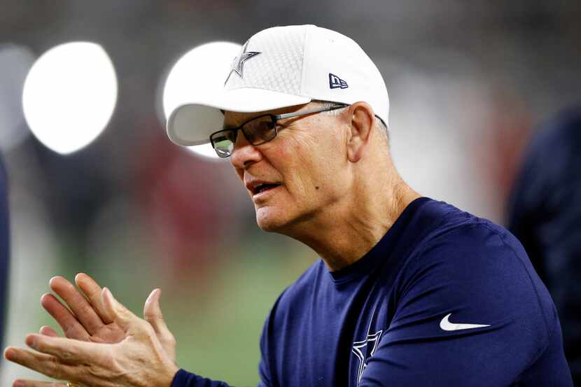 Dallas Cowboys defensive coordinator Rod Marinelli applauds his players as they warmup to...