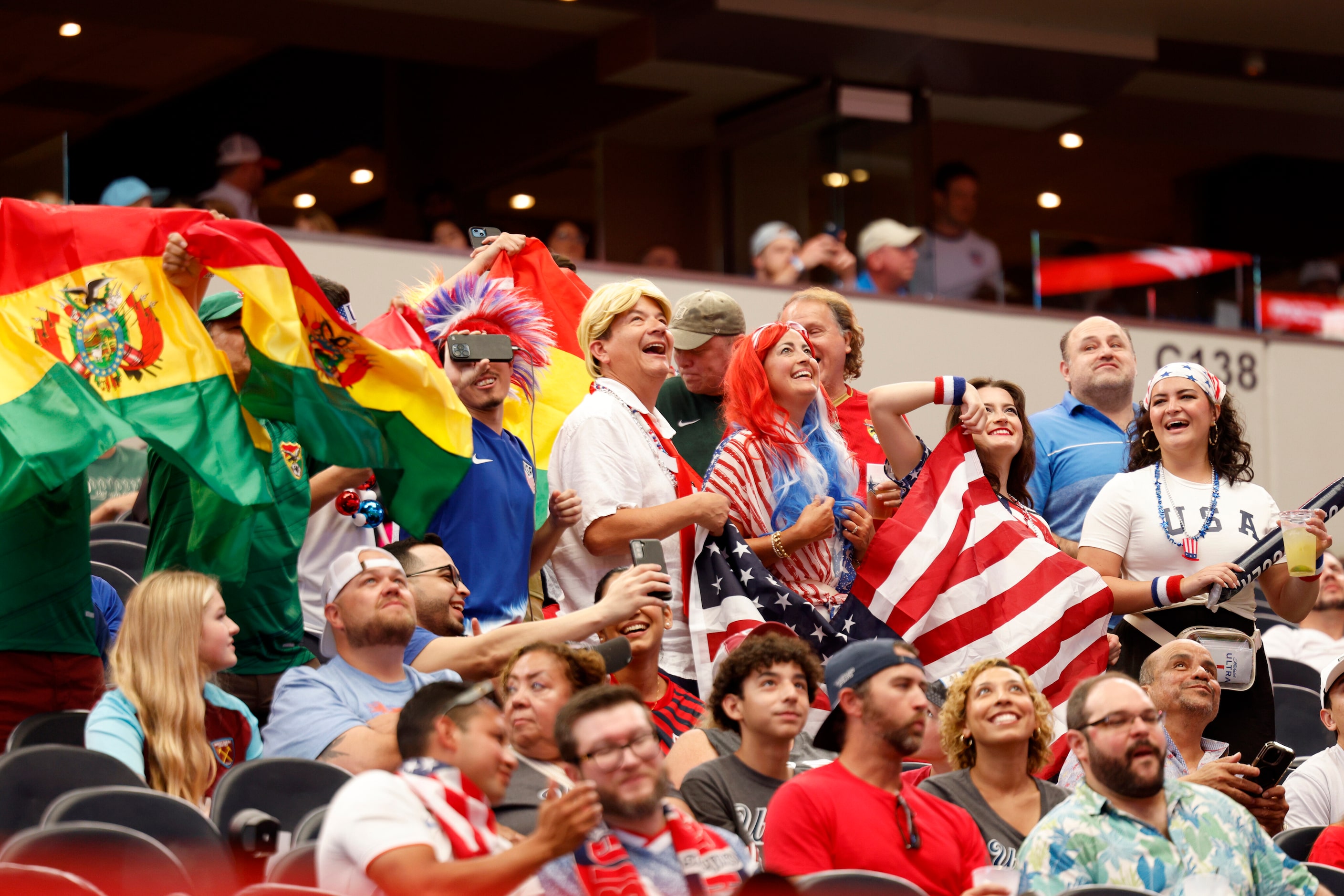 Soccer fans stand and cheer before the first half of a Copa America Group C soccer match...