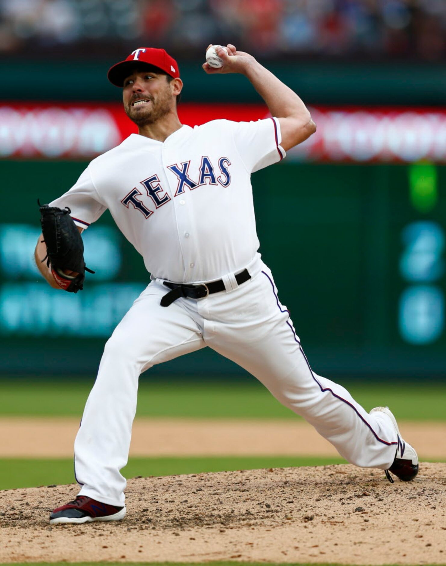 Texas Rangers starting pitcher Matt Moore delivers a pitch to the Seattle Mariners during...