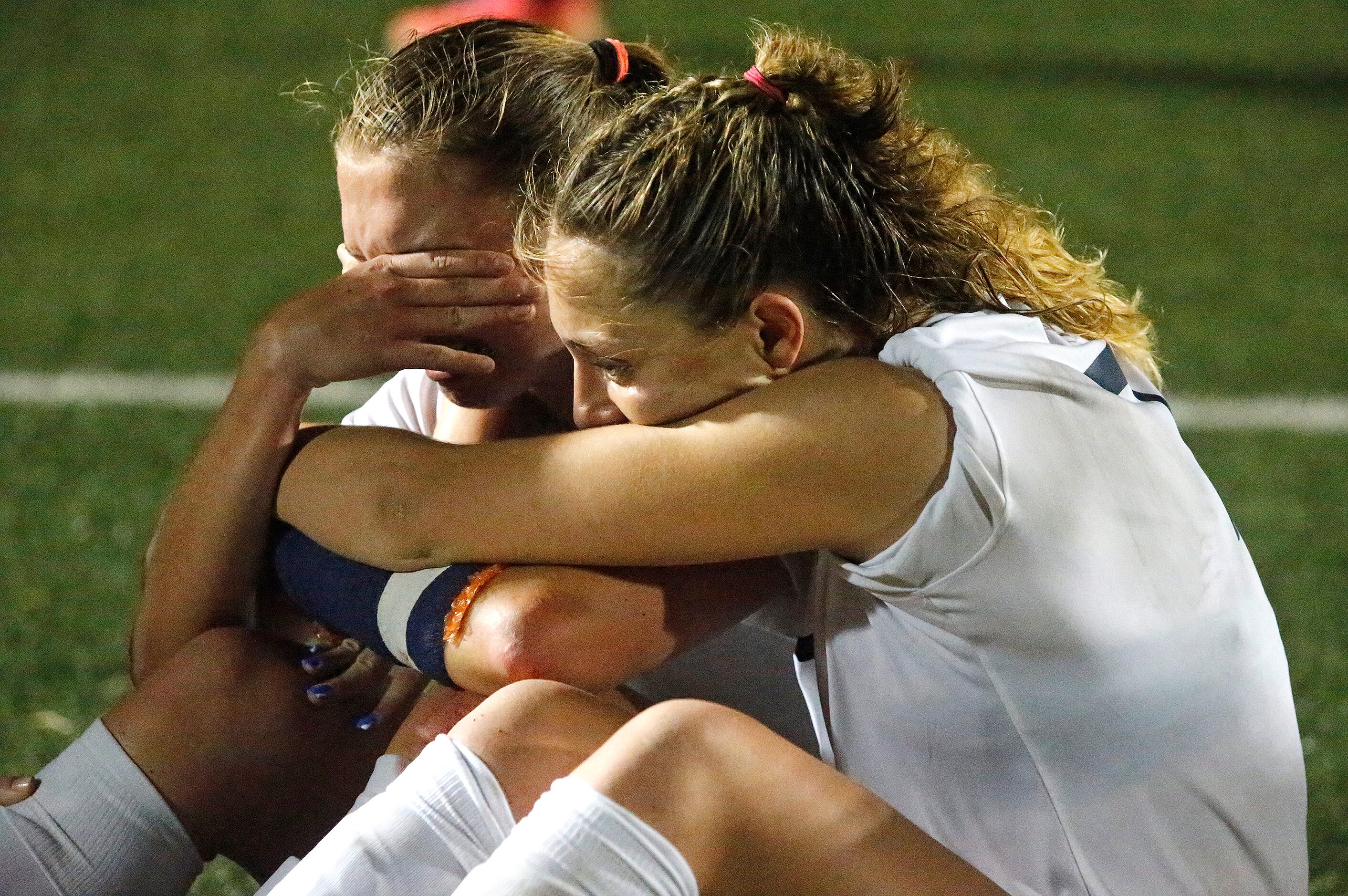 Highland Park midfielders Quinn Cornog (left) and EmJ Cox react to the loss as Wakeland High...