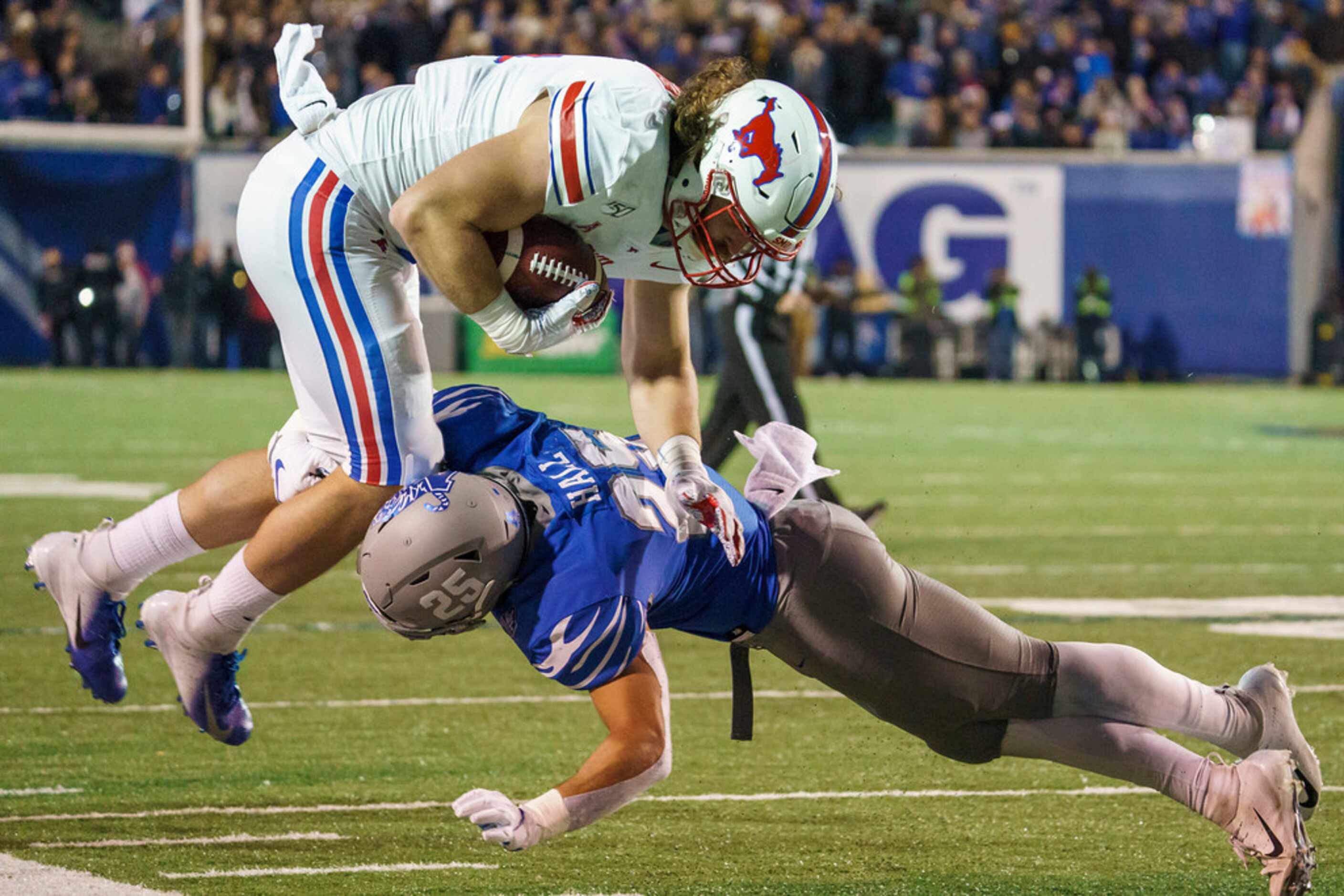 SMU tight end Ryan Becker (14) is knocked off his feet by Memphis linebacker Austin Hall...