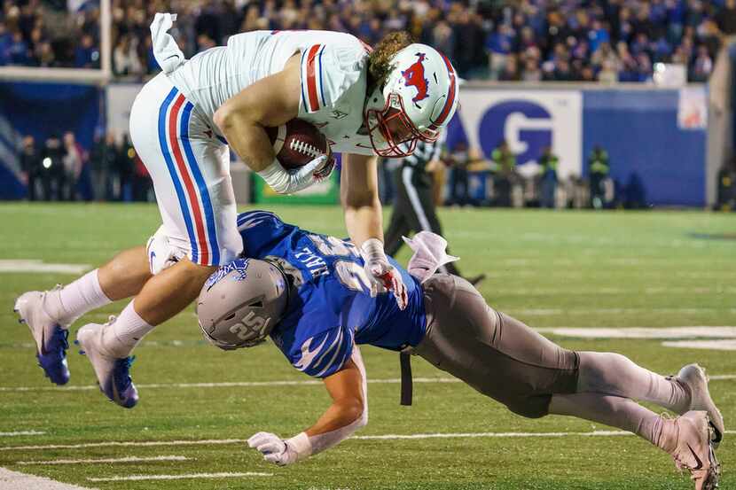 SMU tight end Ryan Becker (14) is knocked off his feet by Memphis linebacker Austin Hall...