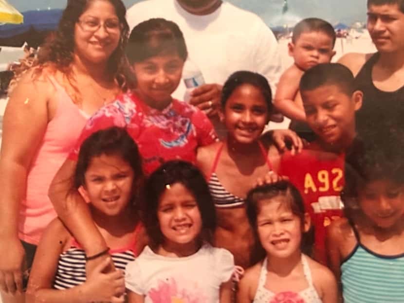Becky Alvarado, left, pictured with her six children and three stepchildren on a family...