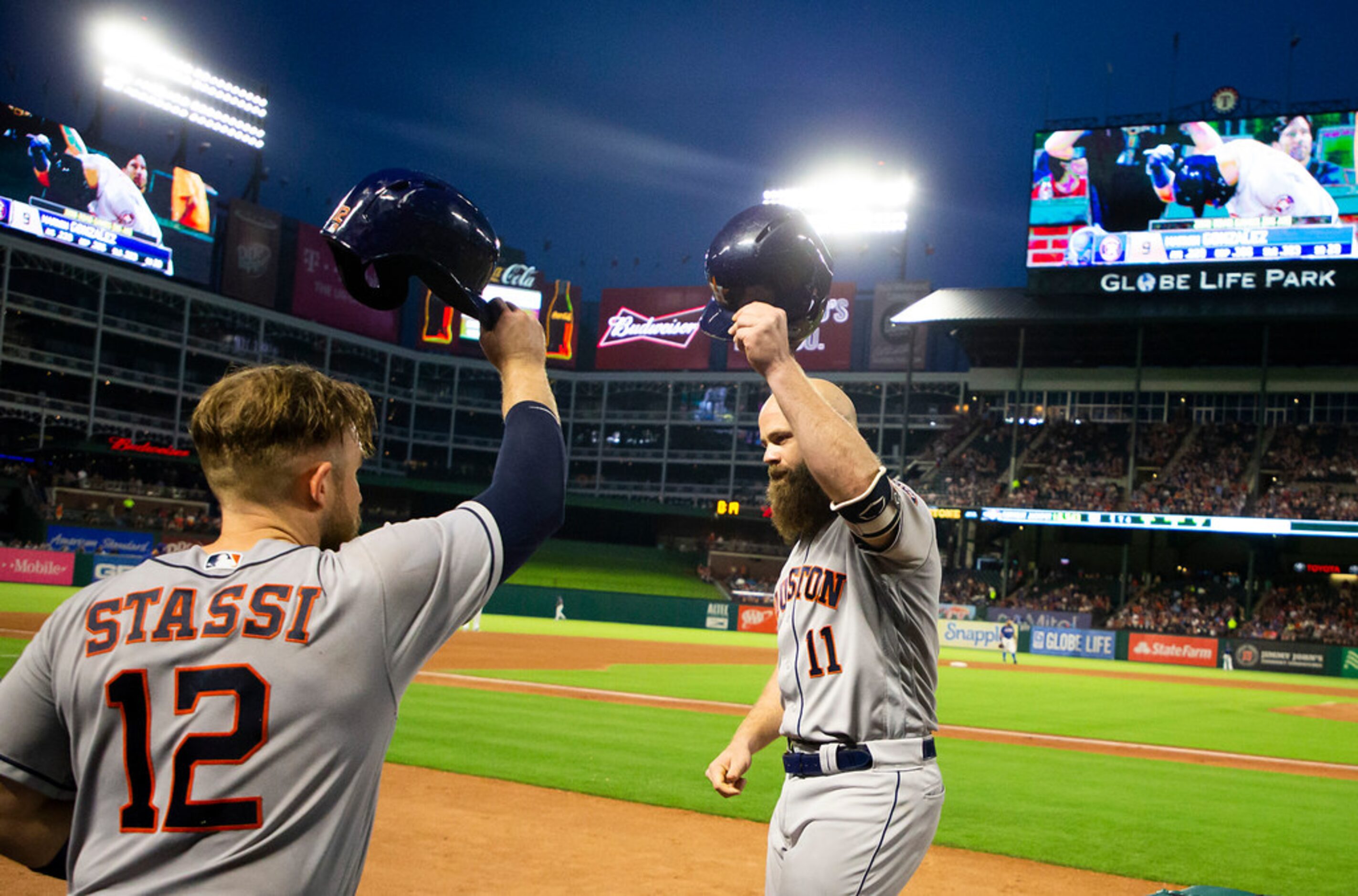 Houston Astros designated hitter Evan Gattis celebrates with Houston Astros catcher Max...