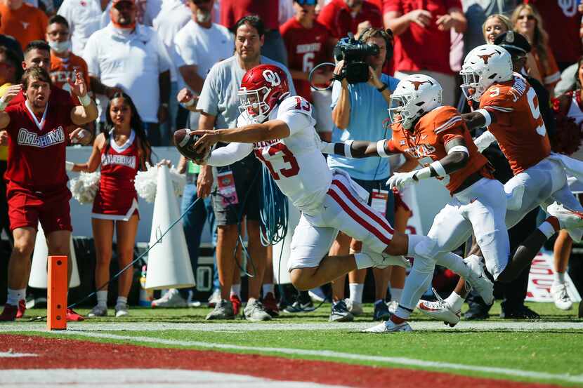 Oklahoma quarterback Caleb Williams (13) dives to score a touchdown during the first half of...
