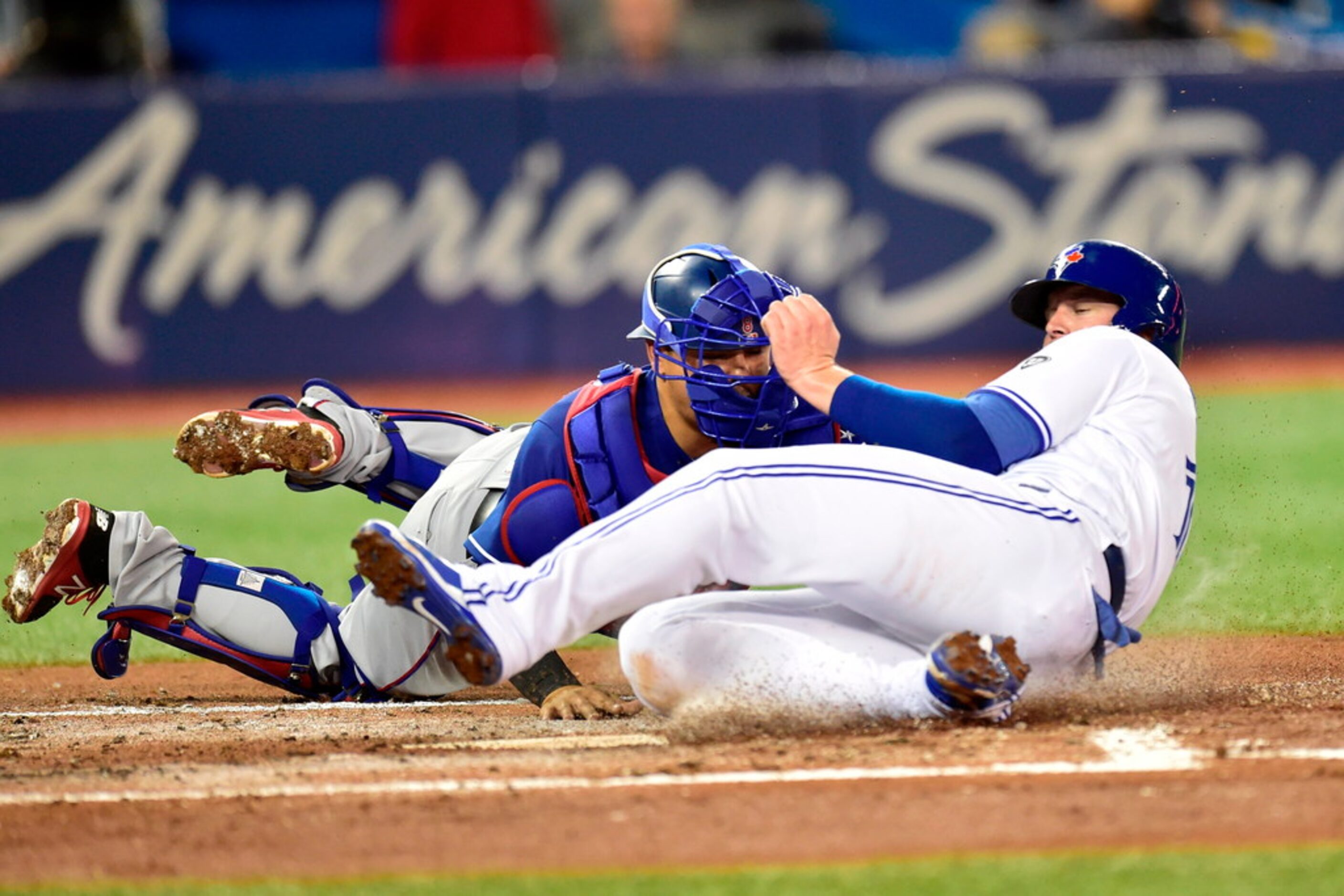 Toronto Blue Jays' Justin Smoak (14) is out at home plate on a tag by Texas Rangers catcher...