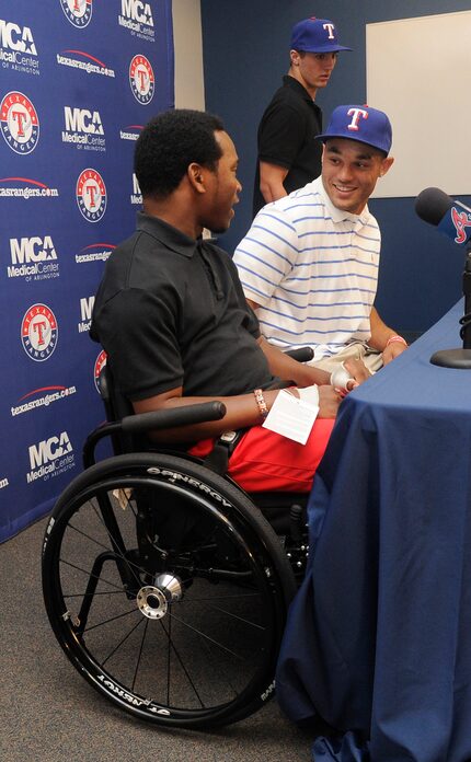 Johnathan Taylor, left and Zach Cone, second from left, attend a press conference held by...