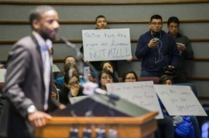  Protesters hold signs in support of Ruben Garcia Villalpando, who was fatally shot by a...