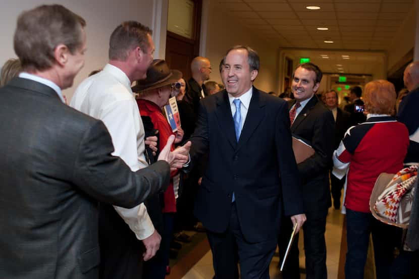 Then-Rep. Ken Paxton, center, is greeted by members of the Tea Party en route to the...