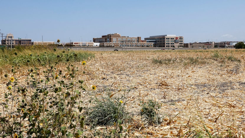 The now-vacant site of a Zarky development at the corner of Dallas Parkway and Main Street...