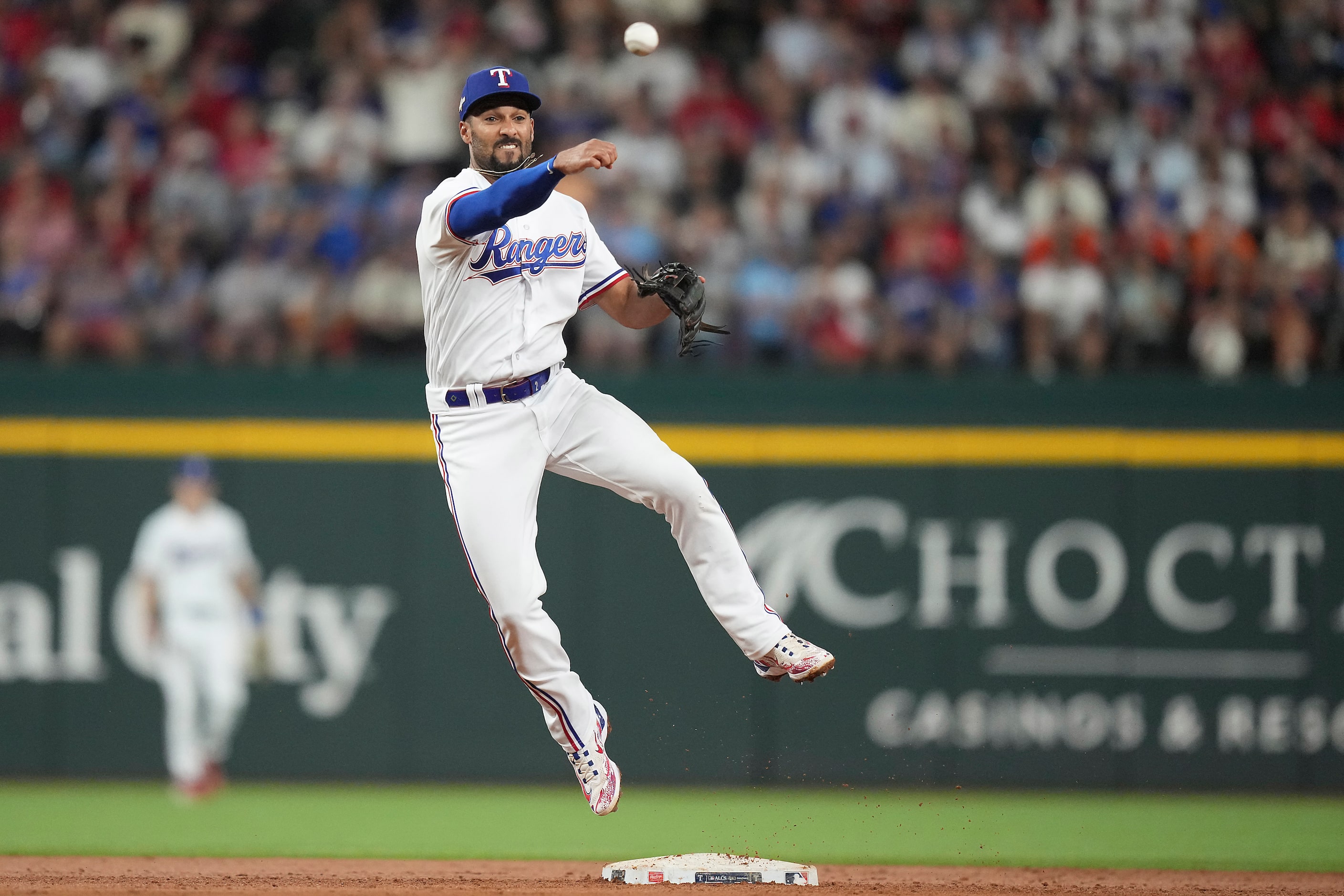 Texas Rangers second baseman Marcus Semien can’t turn a double play on a grounder by Houston...