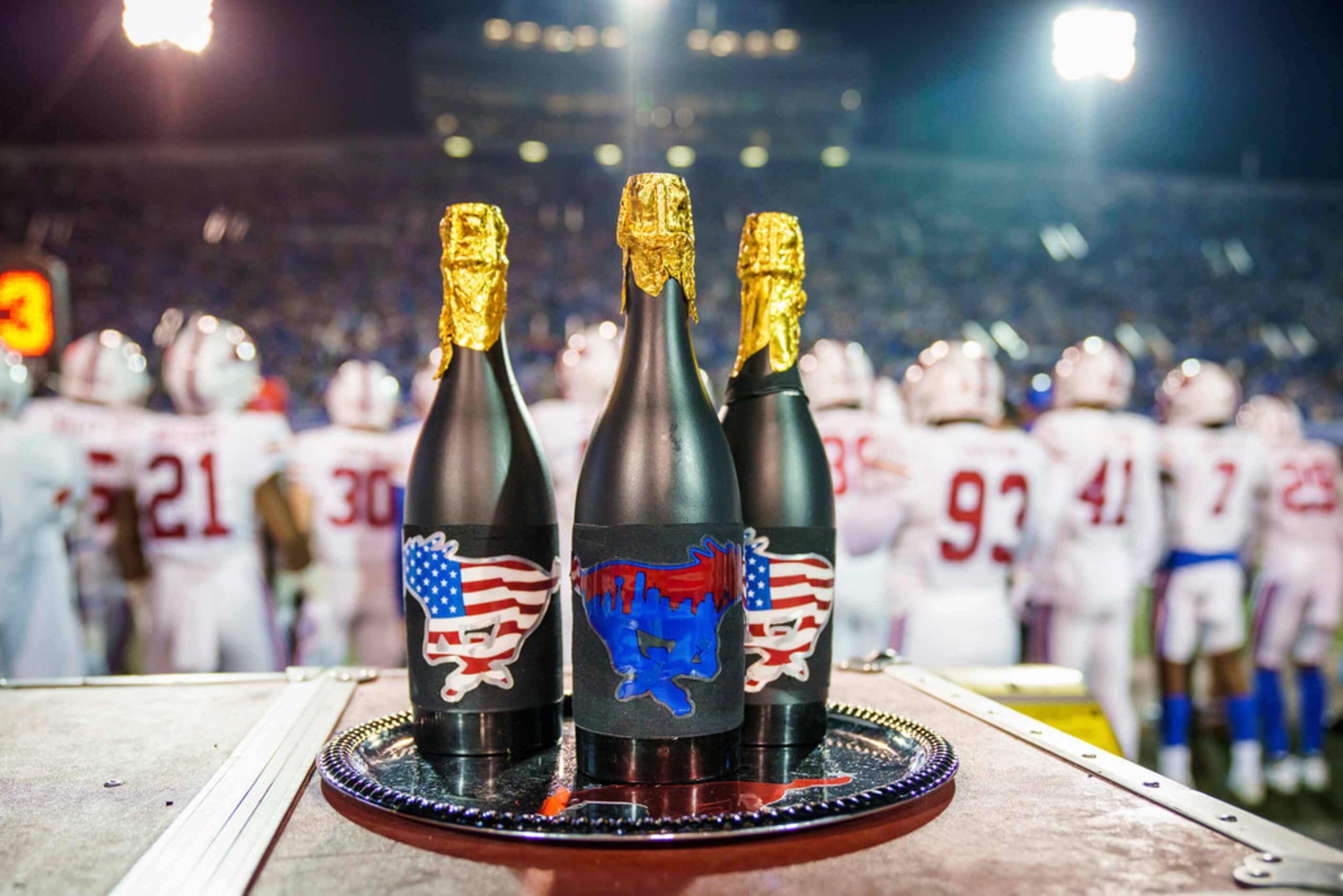 Champagne bottles on the SMU bench during the second half of an NCAA football game against...