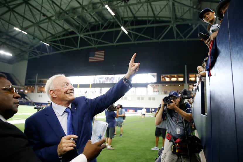 Dallas Cowboys owner and general manager Jerry Jones poses for a fan before practice in the...