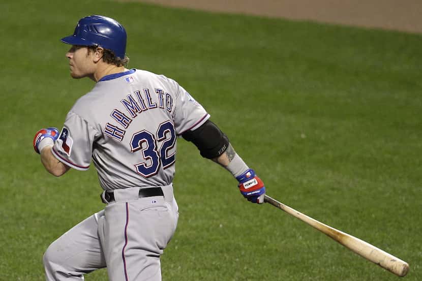 Texas Rangers' Josh Hamilton watches his two-run home run in the eighth inning of a baseball...