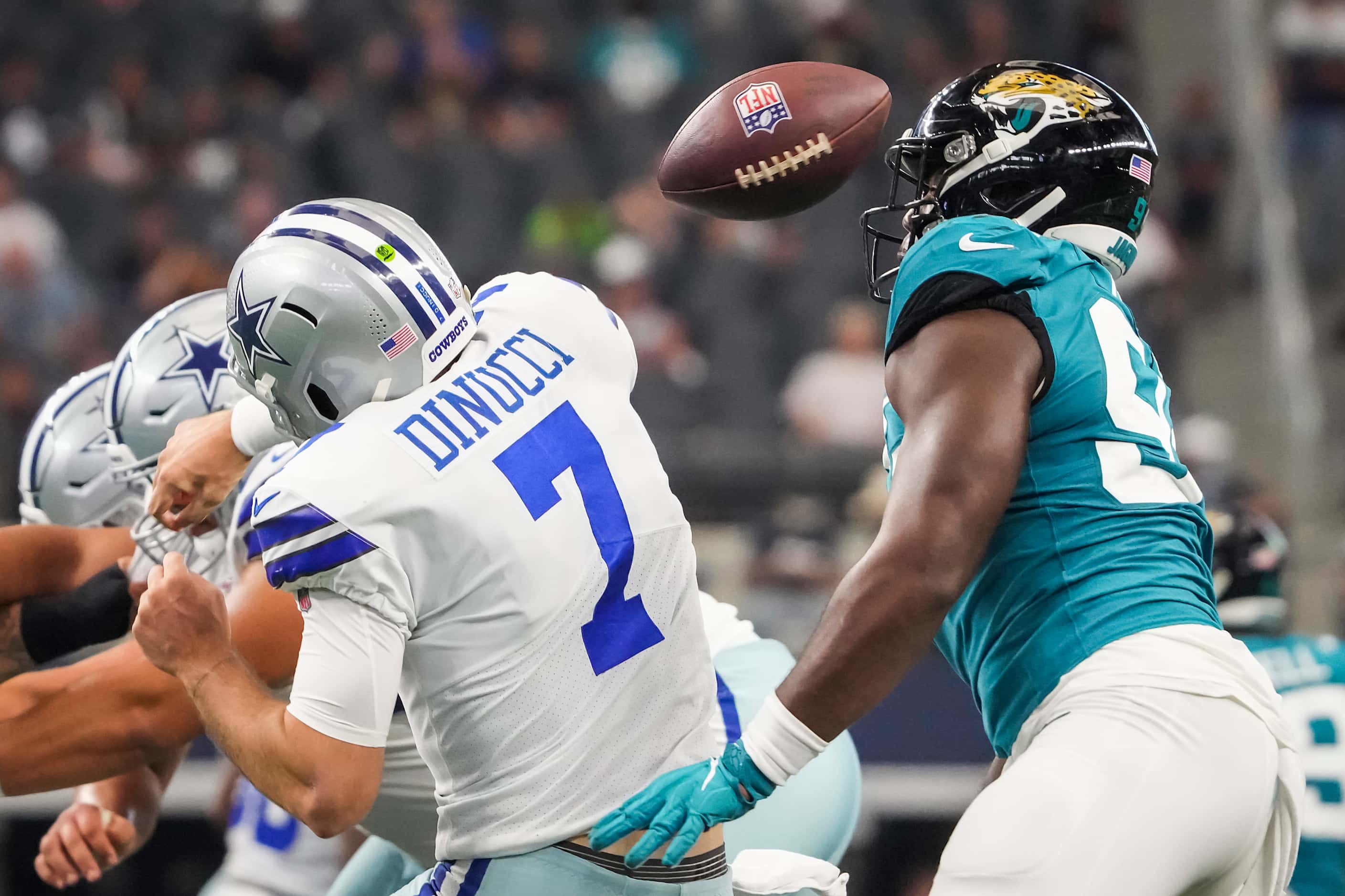 Dallas Cowboys quarterback Ben DiNucci (7) fumbles as he is hit by Jacksonville Jaguars...