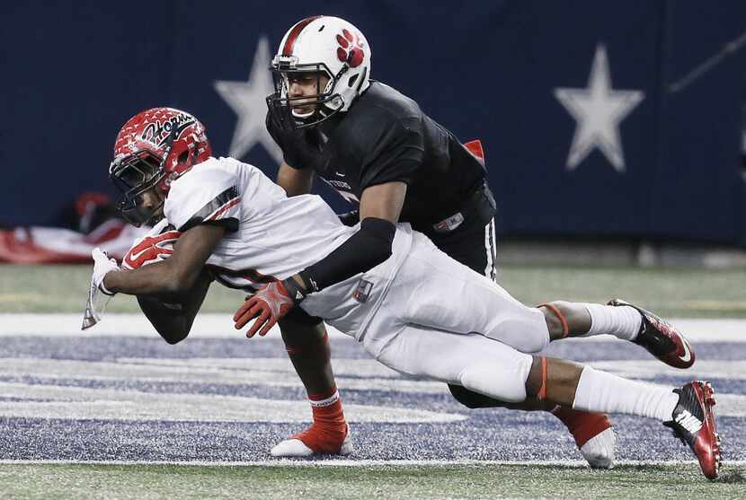 Cedar Hill sophomore running back Jaylon Jackson (10) dives past Colleyville Heritage junior...