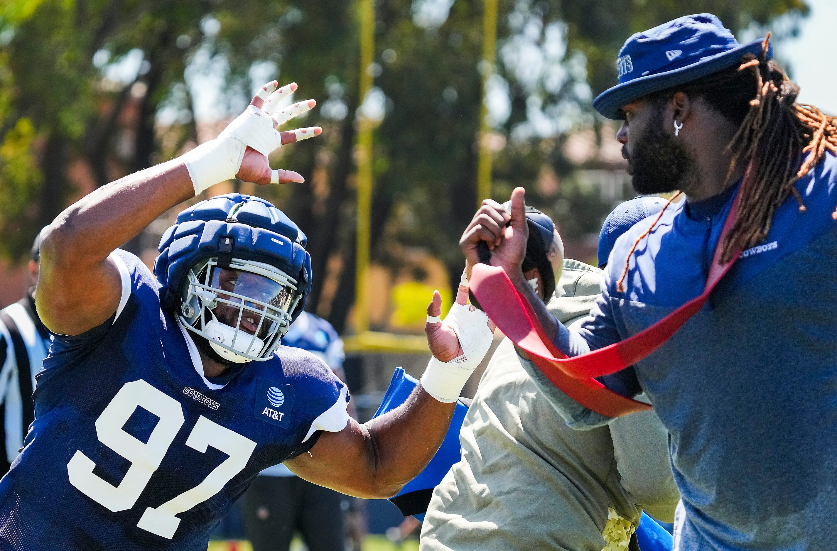 Dallas Cowboys defensive tackle Osa Odighizuwa (97) works with assistant defensive line...