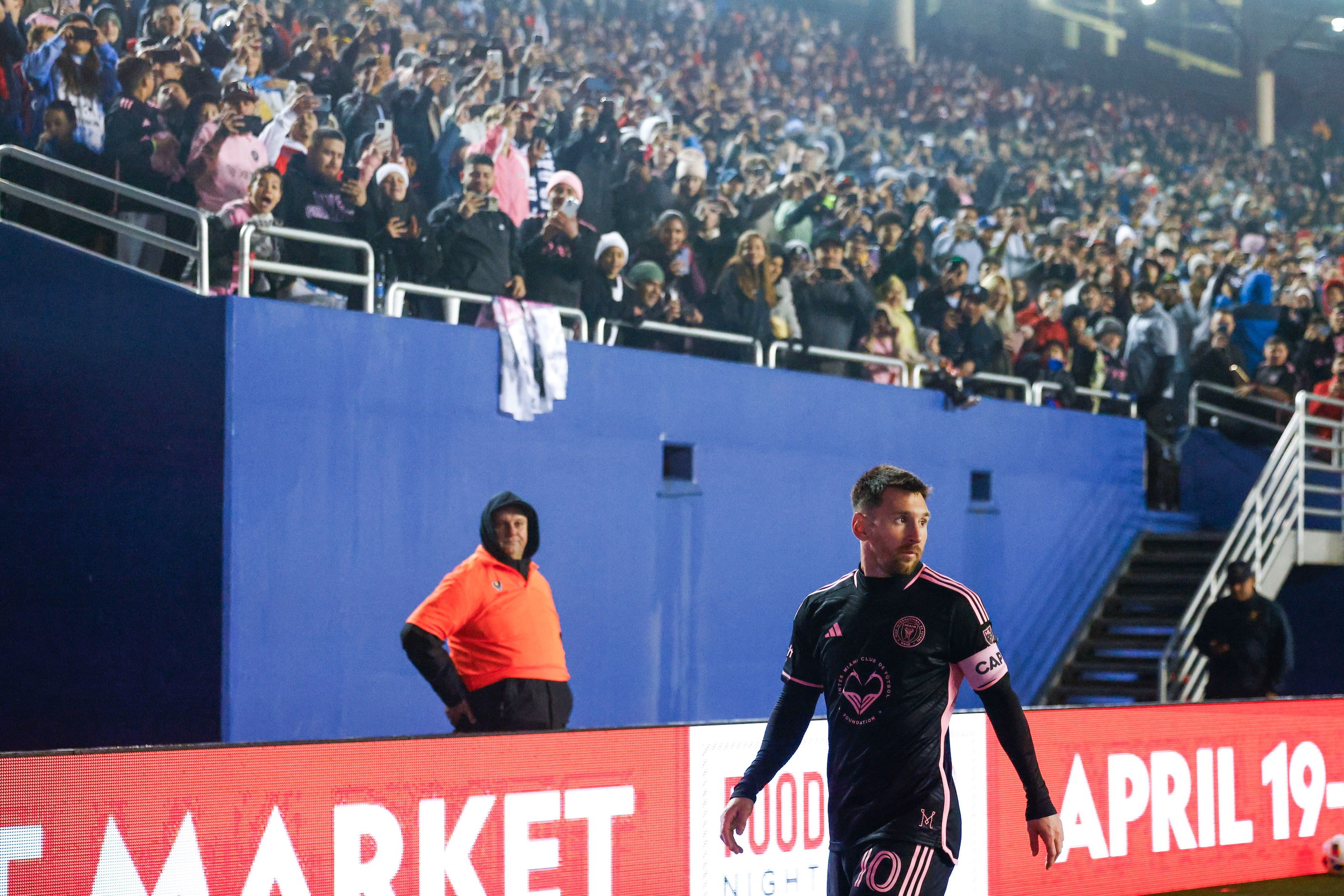 Fans cheer for Inter Miami forward Lionel Messi as he prepares to take a corner kick against...