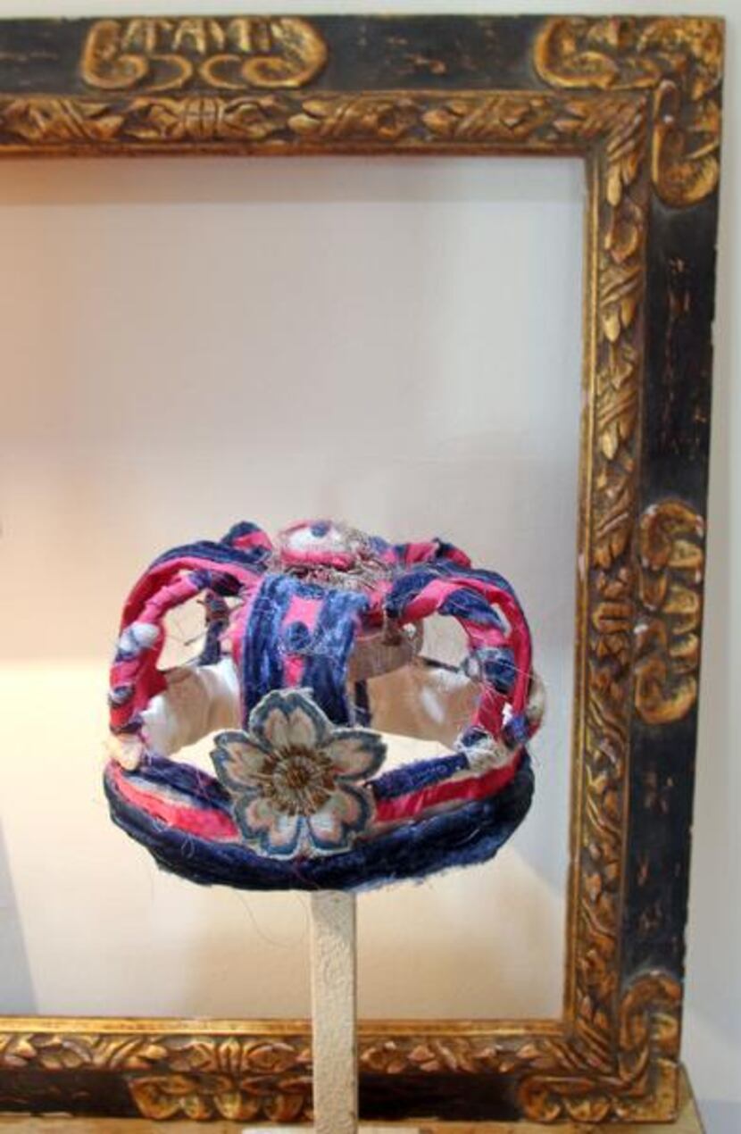 
The crown is a bit of folk art made from bits of colored cloth. The gilded picture frame,...