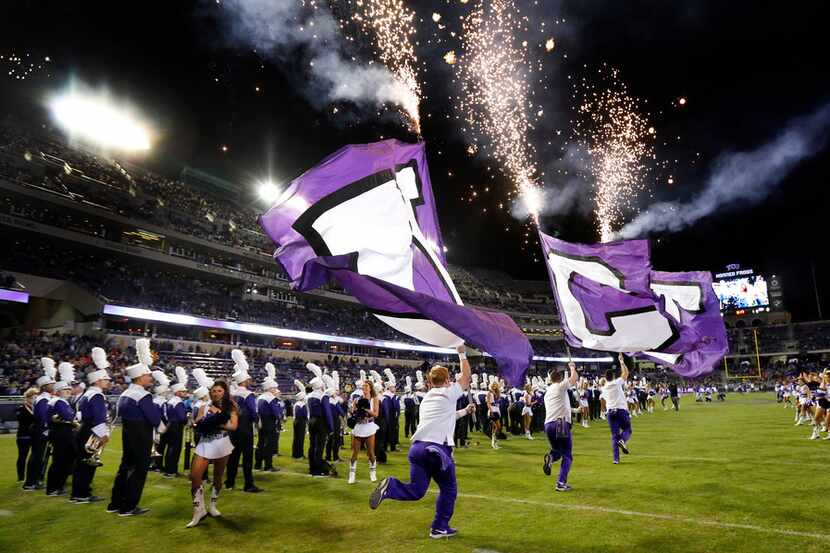 The TCU Horned Frogs cheer squad races onto the field ahead of the football team before they...