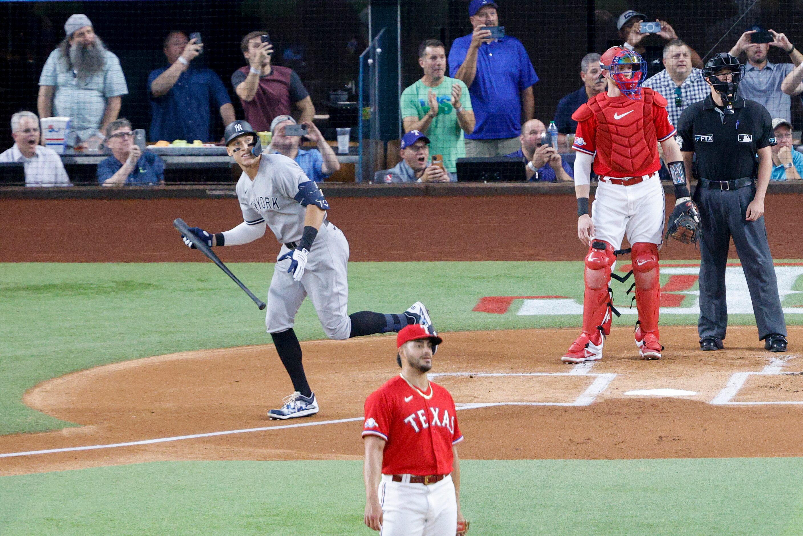 New York Yankees right fielder Aaron Judge (99) watches the ball after hitting a home run to...