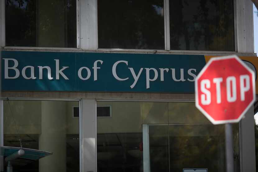 A road traffic "Stop" sign stands outside a Bank of Cyprus Plc branch in Limassol, Cyprus,...