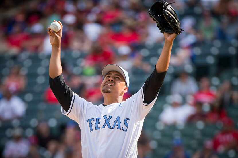 Texas Rangers relief pitcher Ernesto Frieri stretches as he enters the game during the...