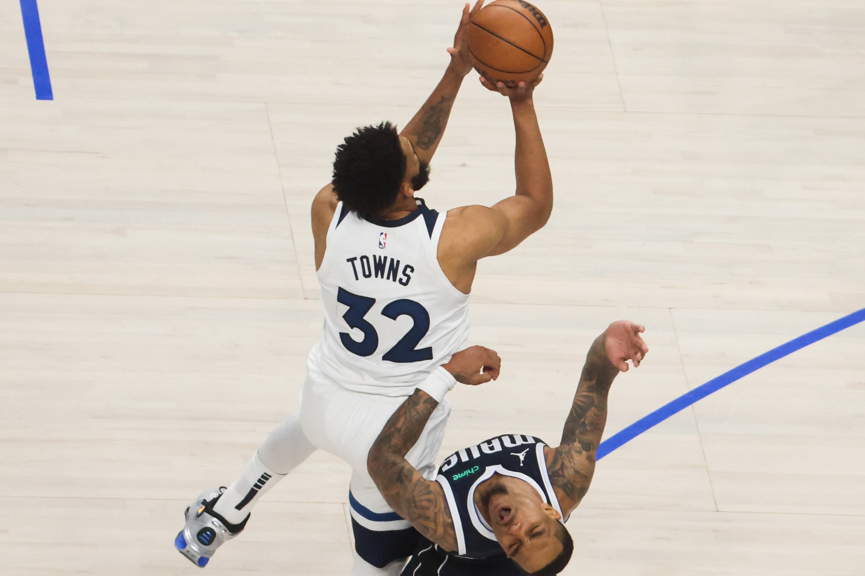 Minnesota Timberwolves center Karl-Anthony Towns (32) fouls Dallas Mavericks forward P.J....