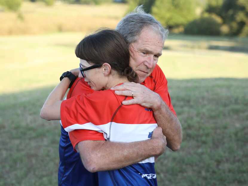 Former Pres. George W. Bush greets a participant in the Warrior 100K. 