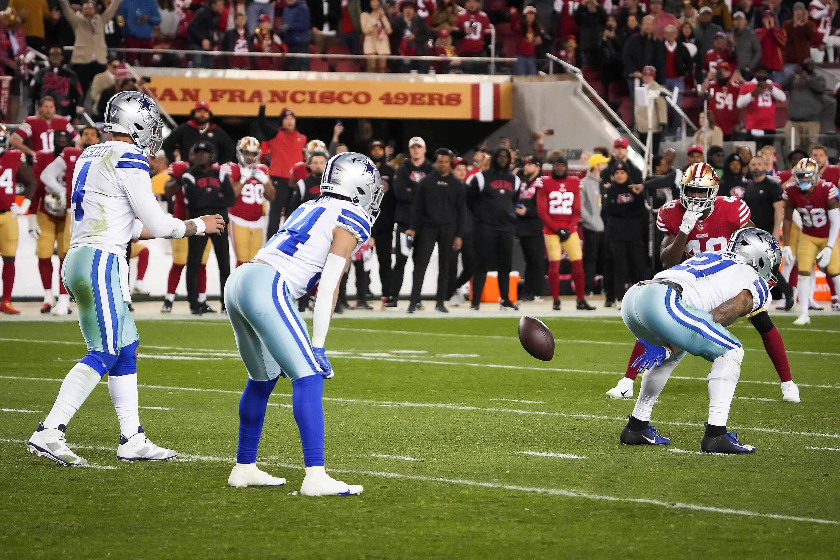 Dallas Cowboys running back Ezekiel Elliott (21) hikes the ball to quarterback Dak Prescott...