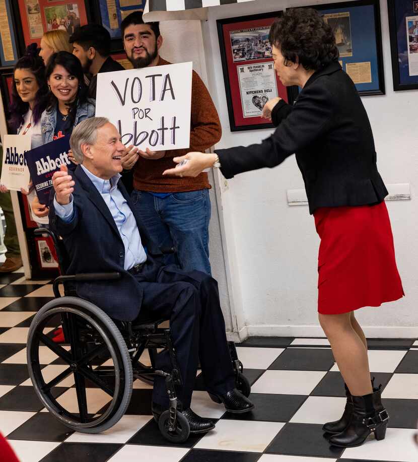 Rep. Button, Angie Chen (right) greets Texas Governor Greg Abbott after announcing him...