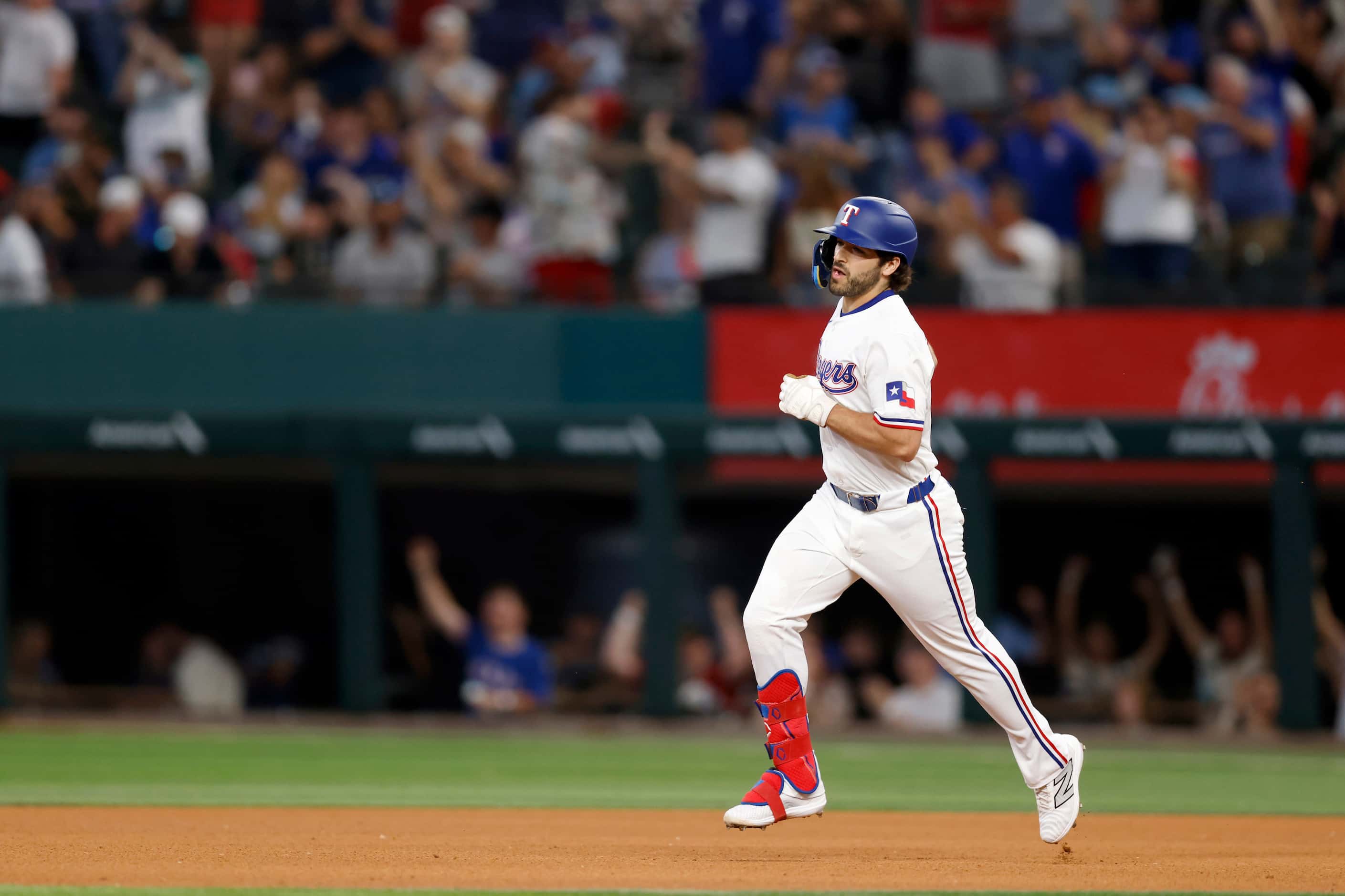 Texas Rangers third baseman Josh Smith (8) rounds the bases after hitting a solo home run...