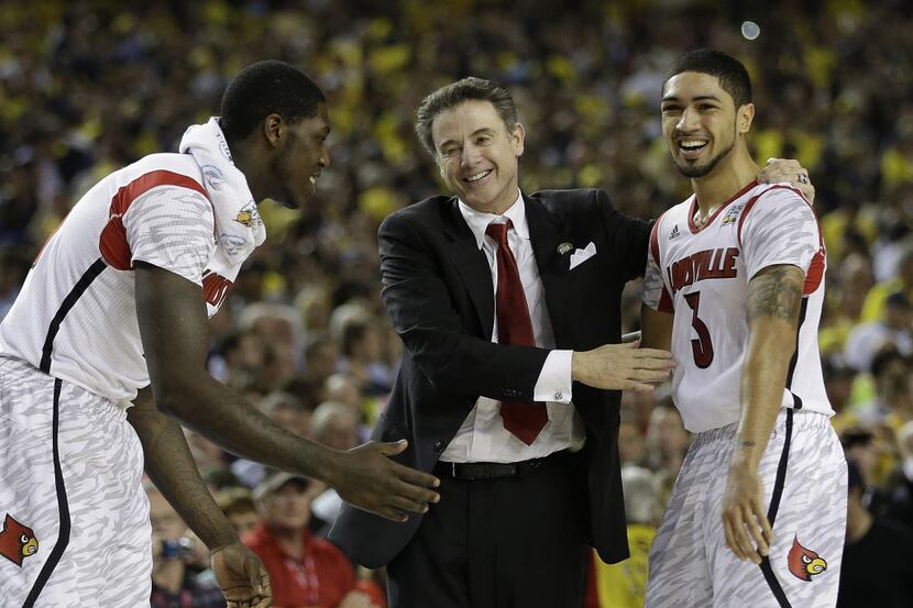 Louisville head coach Rick Pitino and Louisville guard Peyton Siva (3) reacts after...