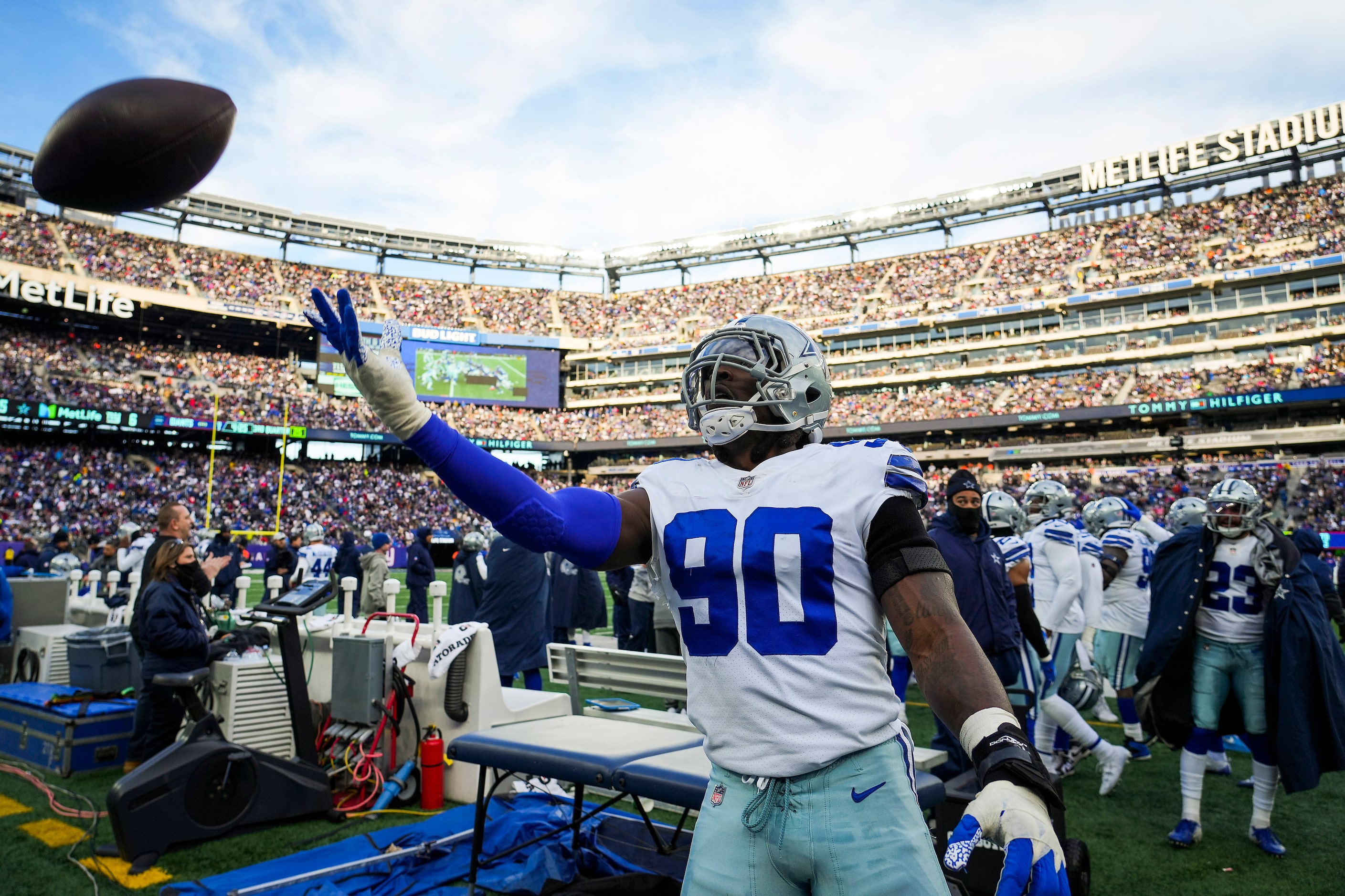 Dallas Cowboys defensive end Demarcus Lawrence (90) tosses a ball to the stands after a New...