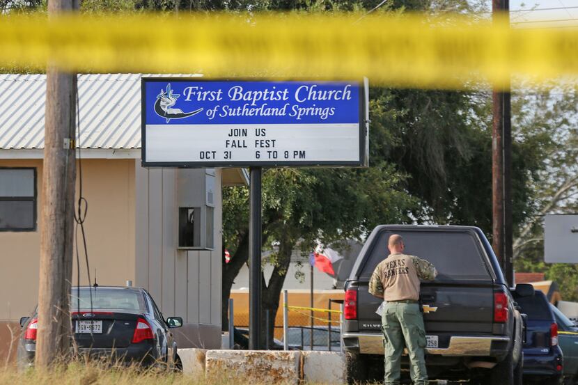 A Texas Ranger works the scene as the investigation continues Monday at First Baptist Church...