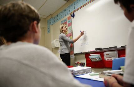 Teacher Lisa Hamilton decodes a word with students during a multi sensory approach class for...