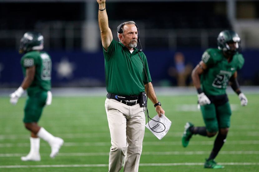 Kennedale's head coach Richard Barrett signals going for one on the point after touchdown...