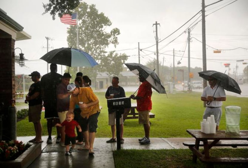 
Customers who didn’t show up early enough endured squalls of rain while waiting outside...