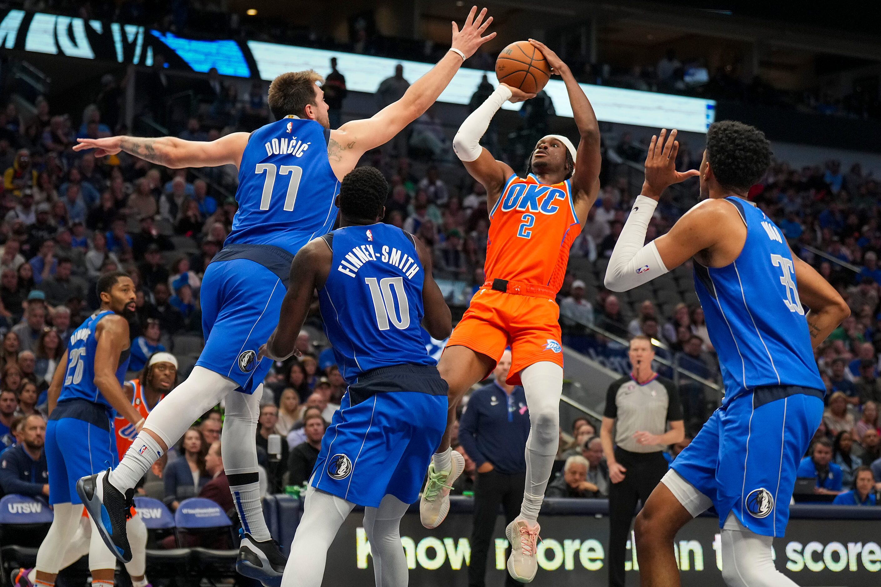 Oklahoma City Thunder guard Shai Gilgeous-Alexander (2) scores over Dallas Mavericks guard...