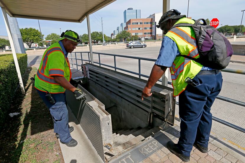Pedestrians passing over steel plates in the sidewalk along Willis Avenue at Central...