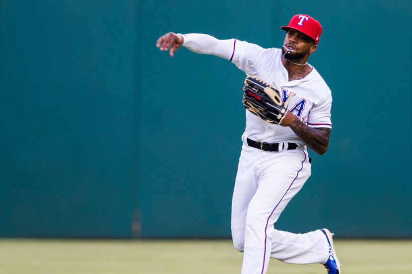 Texas Rangers center fielder Delino DeShields (3) throws in a ball from the outfield during...