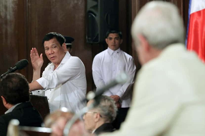 Philippine President Rodrigo R. Duterte (R) gesturing while answering a question during a...