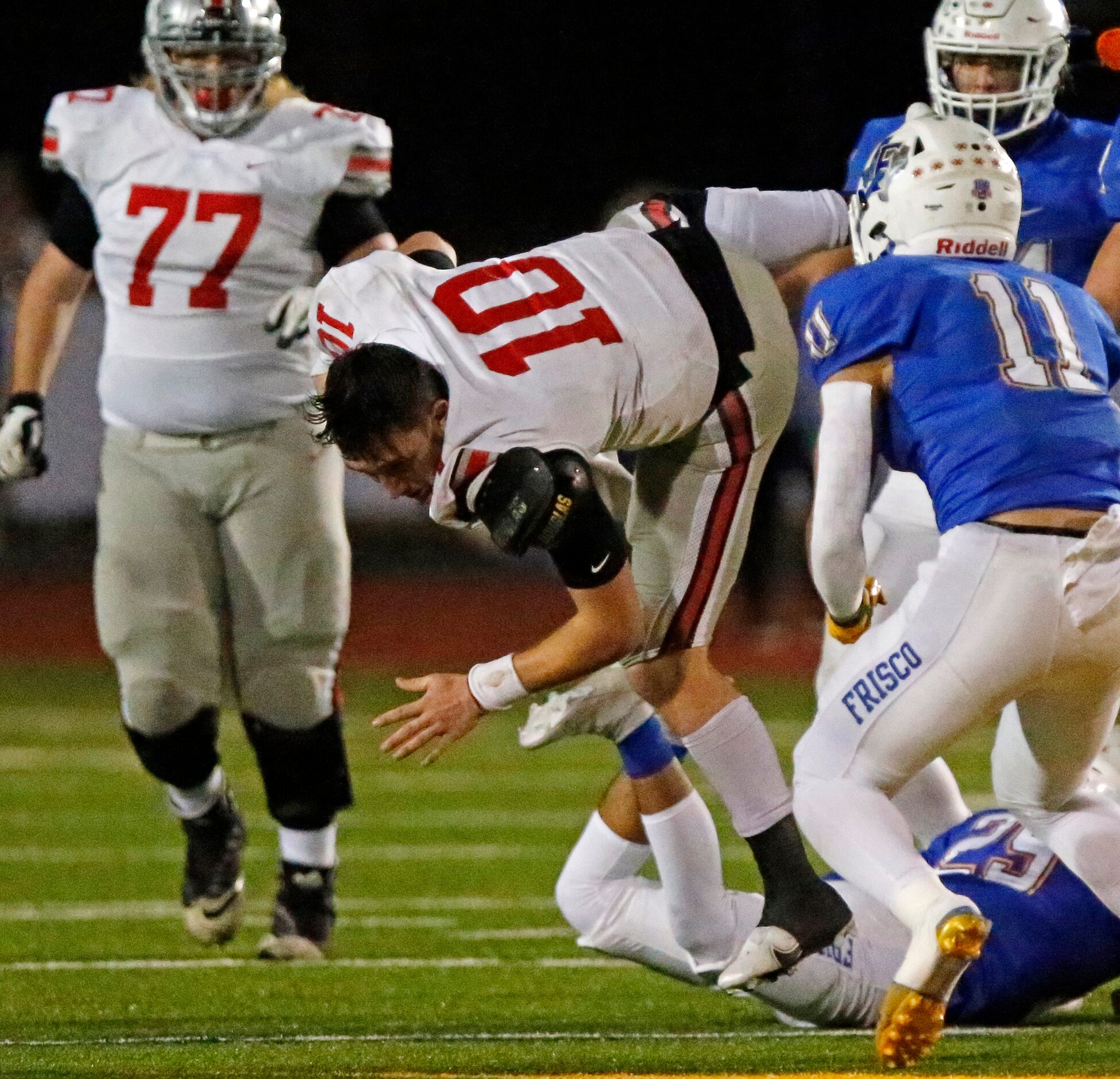 Lovejoy High School quarterback R.W. Rucker (10) looses his helmet during the first half as...